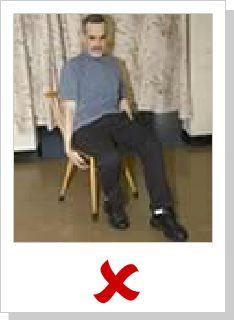 patient sitting in chair but arms unsupported and lying limp at sides