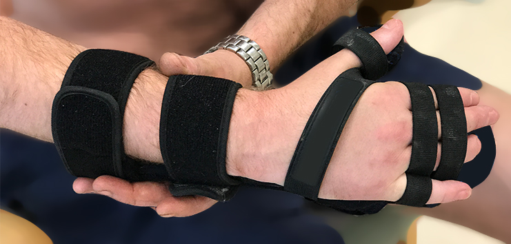 Wrist orthosis equipment being fitted with straps around forearm, palm and fingers