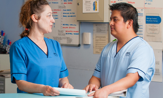 two care staff discussing something
